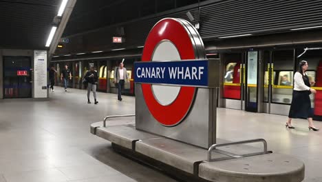 people walking on the platform at canary wharf london underground station