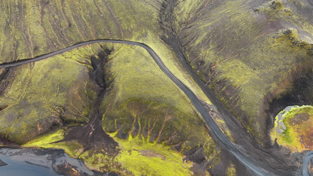 vista aérea de la carretera que atraviesa colinas cubiertas de musgo, montañas en islandia