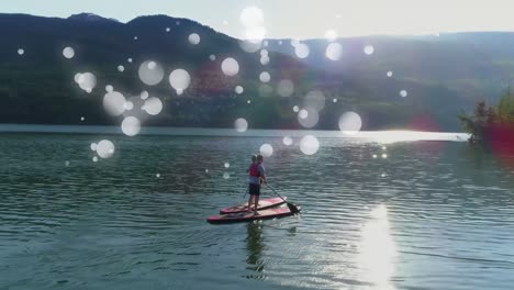 Couple-doing-paddle-board-surrounded-by-white-bubbles-effect