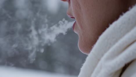 woman exhaling in cold winter weather