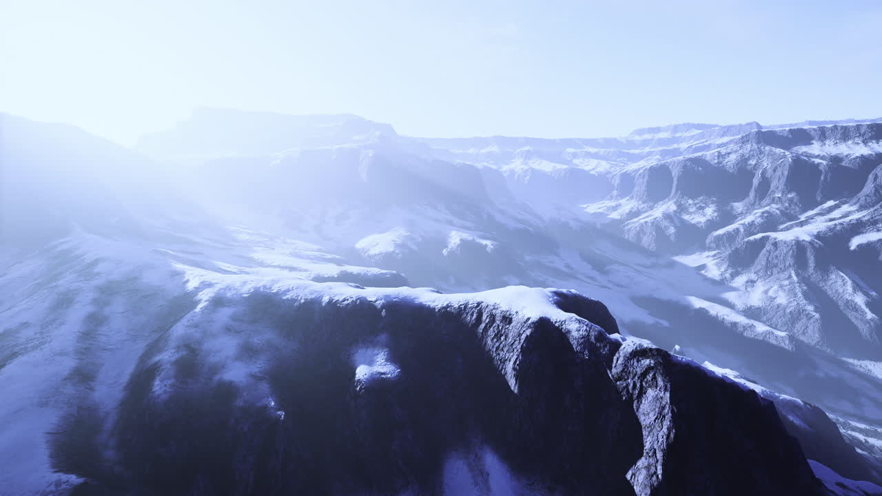 Snowy mountains under bright morning light create a serene scene