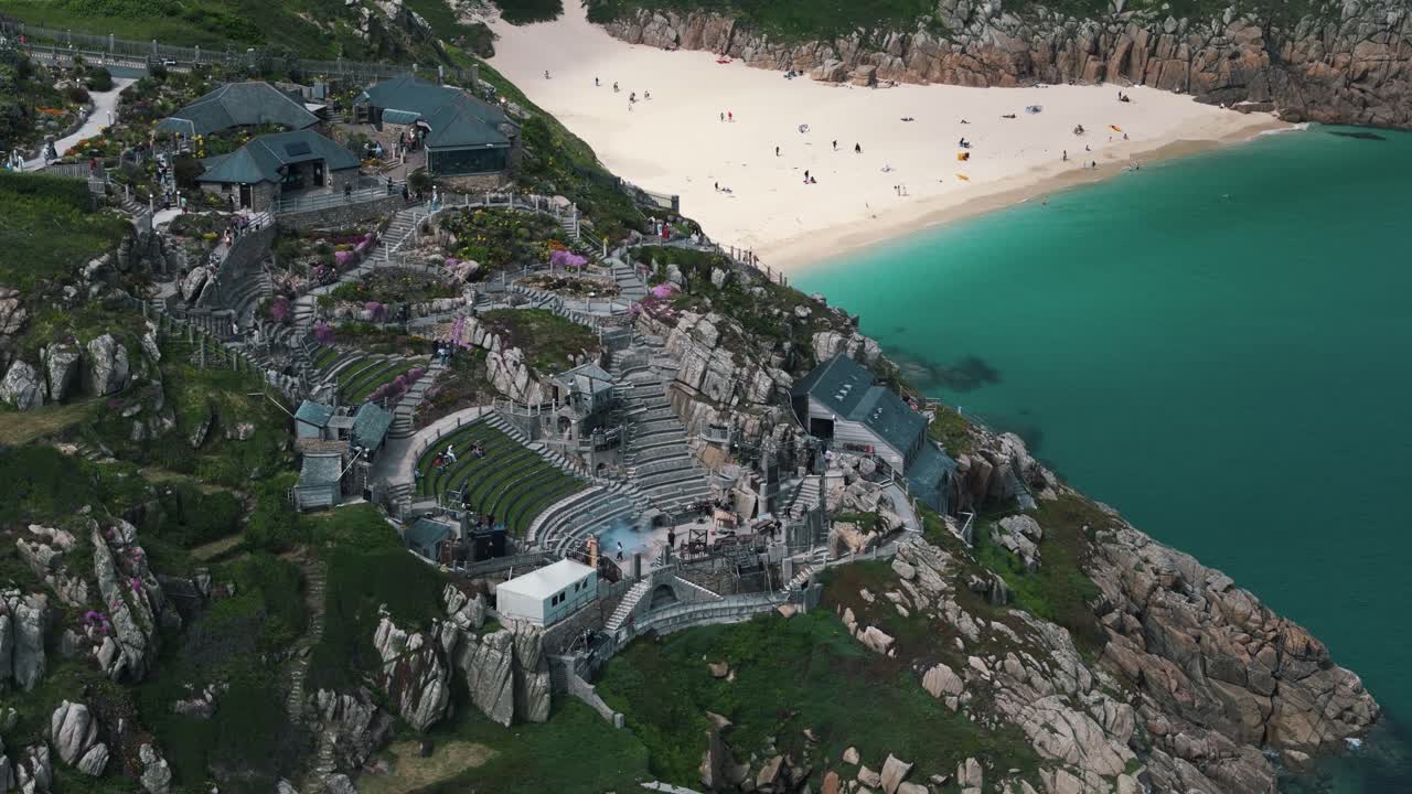 Retreating pan up circling left over Minack Theatre and surrounding cliffs