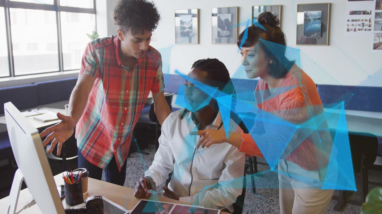 Team seeing blue holographic overlay on monitor and pointing, updating business dashboard model