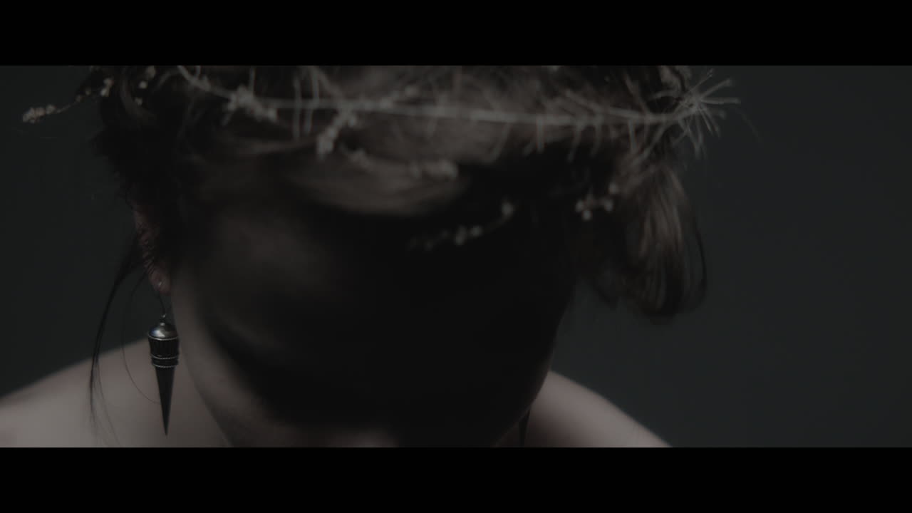 A woman dressed as mother nature shows her hair