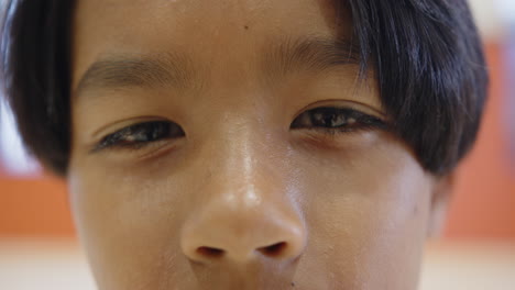 close-up of child's face, smiling and enjoying time at school