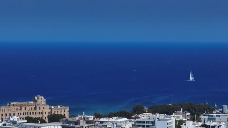 telephoto drone shot of the cityscape and sea at rhodes city, in sunny greece