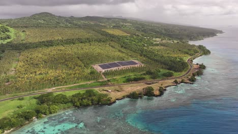 aerial view of a tropical island with solar panels