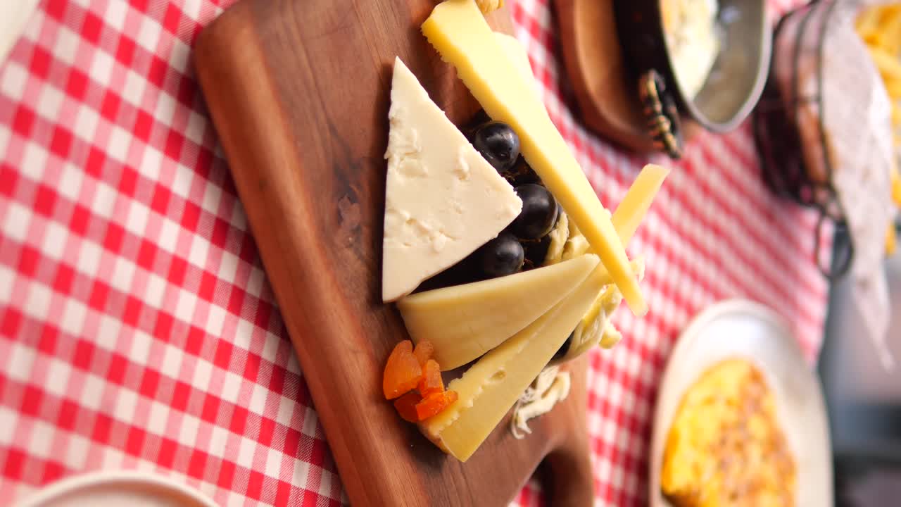 Cheese board with grapes and dried apricots