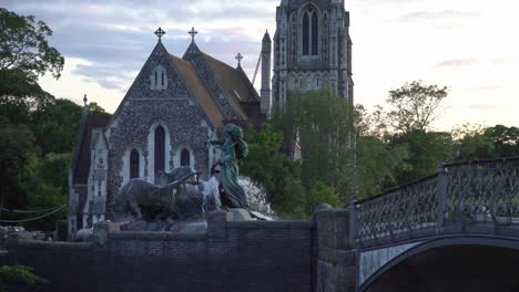 Statue-and-fountain-in-front-of-a-church-in-Copenhagen,-Denmark