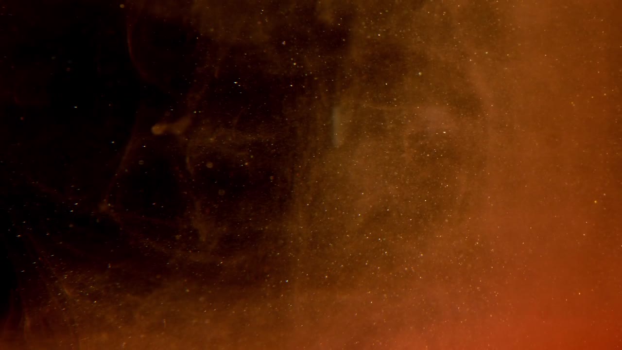 Liquido astratto vorticoso marrone e arancione con particelle scintillanti