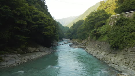 blue-green river flowing through mountains on the island of shikoku, japan