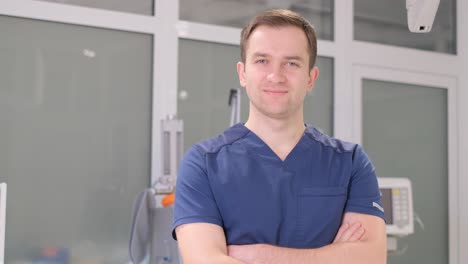 Portrait of a Male Doctor in Blue Overalls Looking at the Camera and Smiling. Portrait of a male doctor in blue overalls looking at the camera and smiling. video