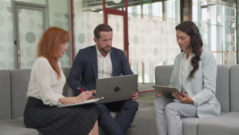 work team composed of two women and a man in a meeting put things in common in a relaxed atmosphere