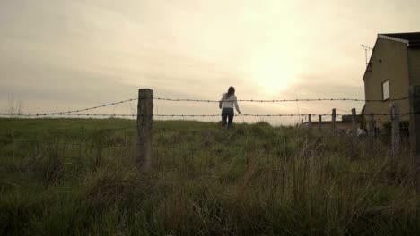 Woman-running-through-barbed-wire-field