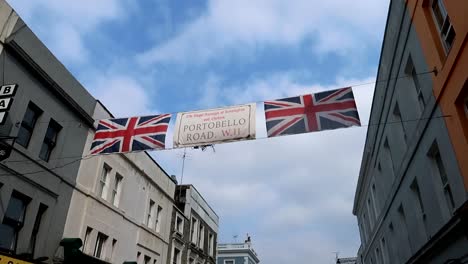 static view of united kingdom flags in portobello road while clouds are moving in the sky