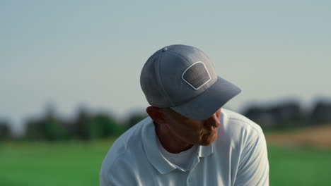 senior hitting golf ball on course. rich man play golfing game on sunny weekend.