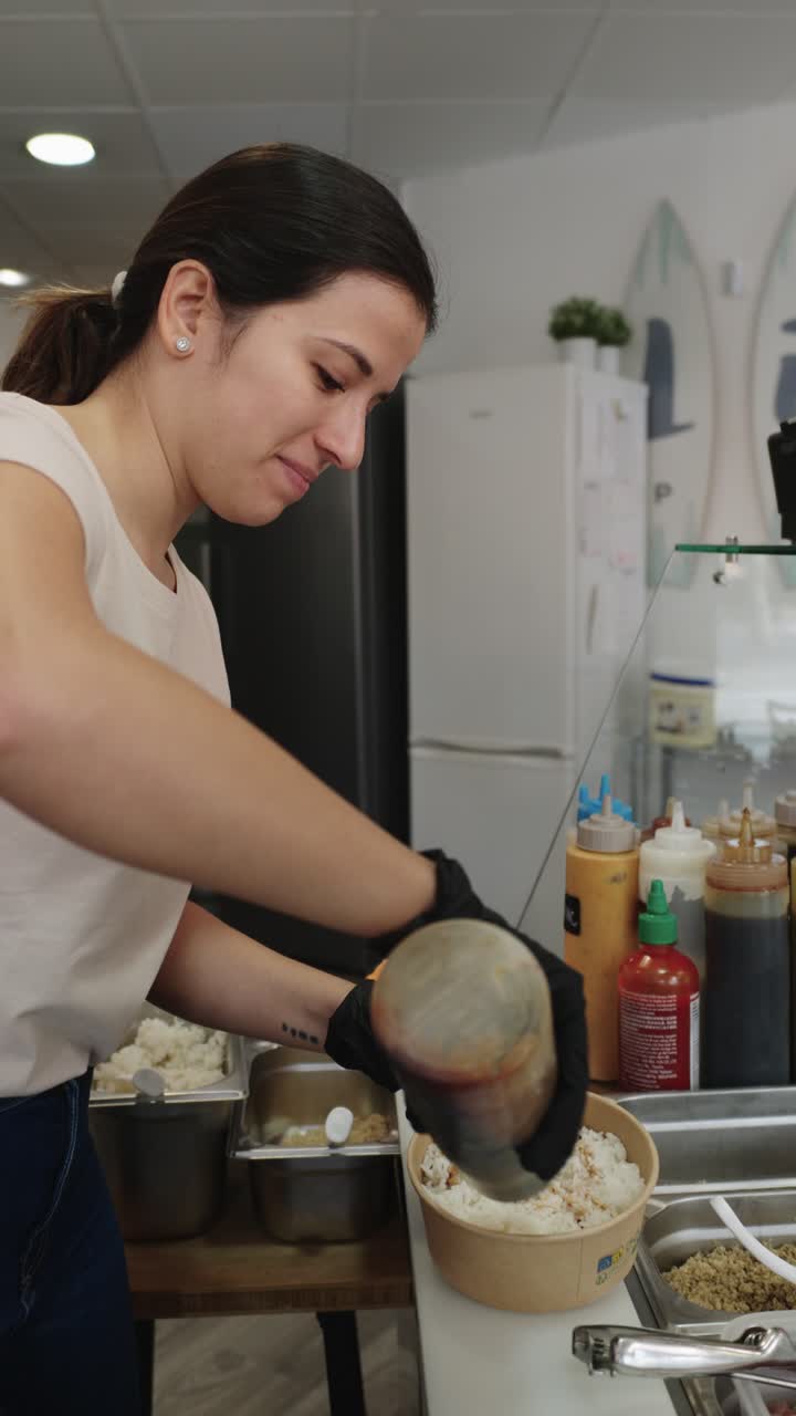 A woman preparing food in a restaurant kitchen