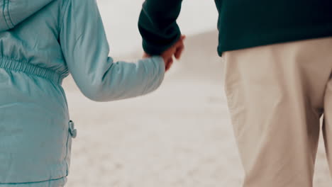 Beach,-kid-and-father-are-holding-hands