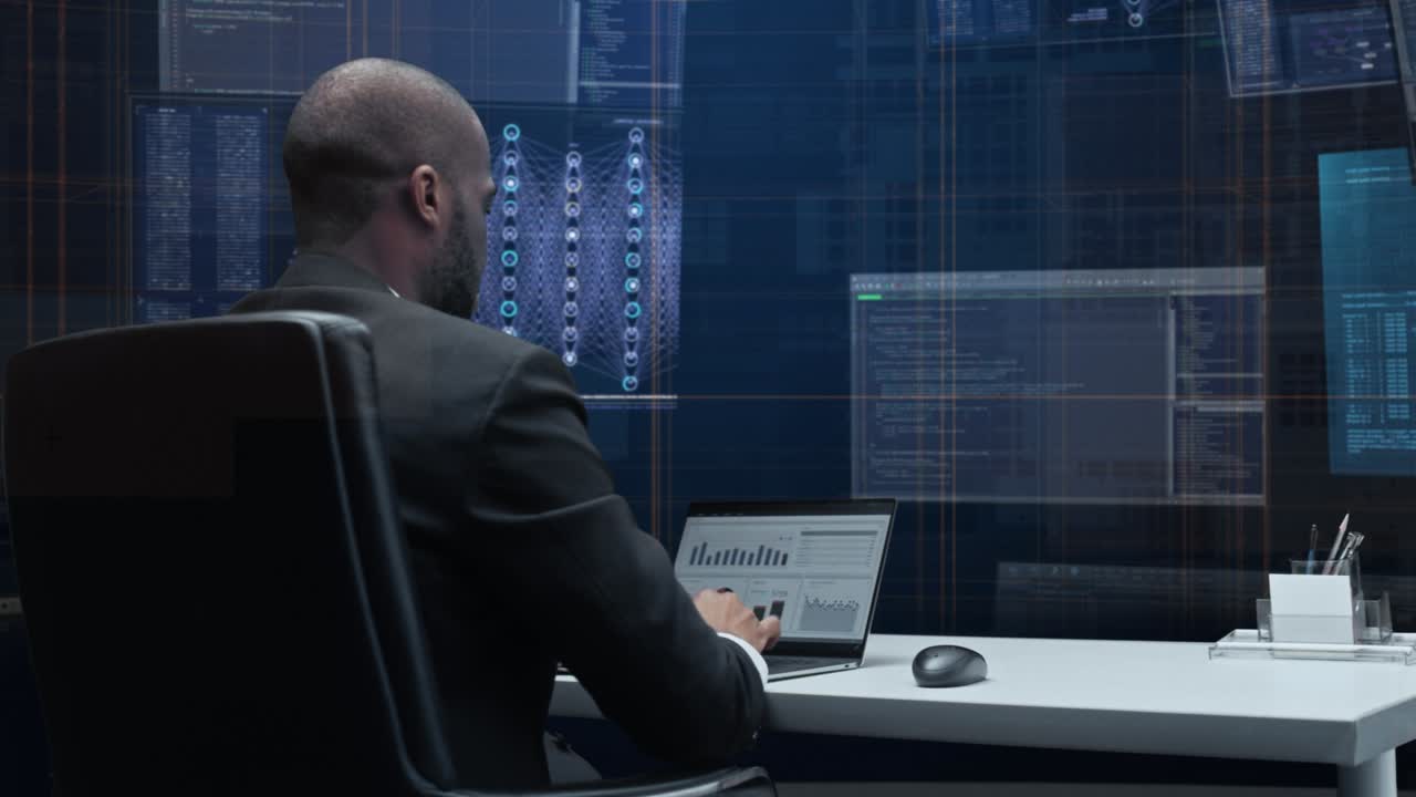 Office Manager with Animated Virtual Background: Businessman Sitting at a Desk Working on a Laptop Computer. Man Working with Big Data Finance Analysis. 360 Degree Tracking Shot. Camera Moving Around.