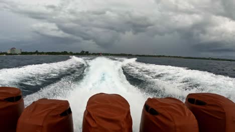 stern wave on surface seawater behind speedboat slowmo