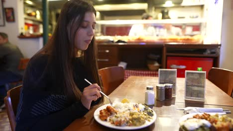 young woman eating turkish food in a restaurant