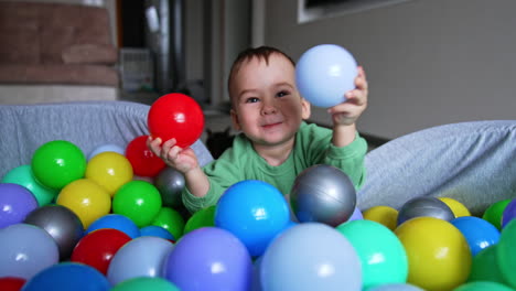 baby playing in a ball pit