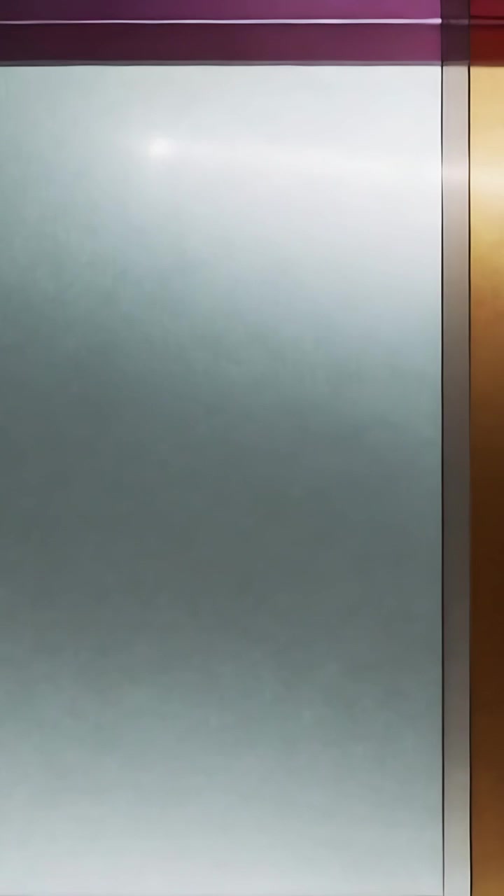 Vertical video: Panning camera revealing frosted glass panel in lobby, highlighting colored bands