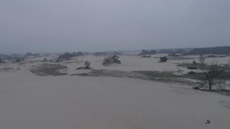 Forward-moving-drone-shot-of-a-sandplain-or-desert-type-nature