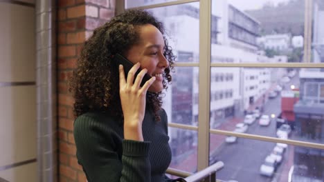 creative businesswoman talking on smartphone in modern office