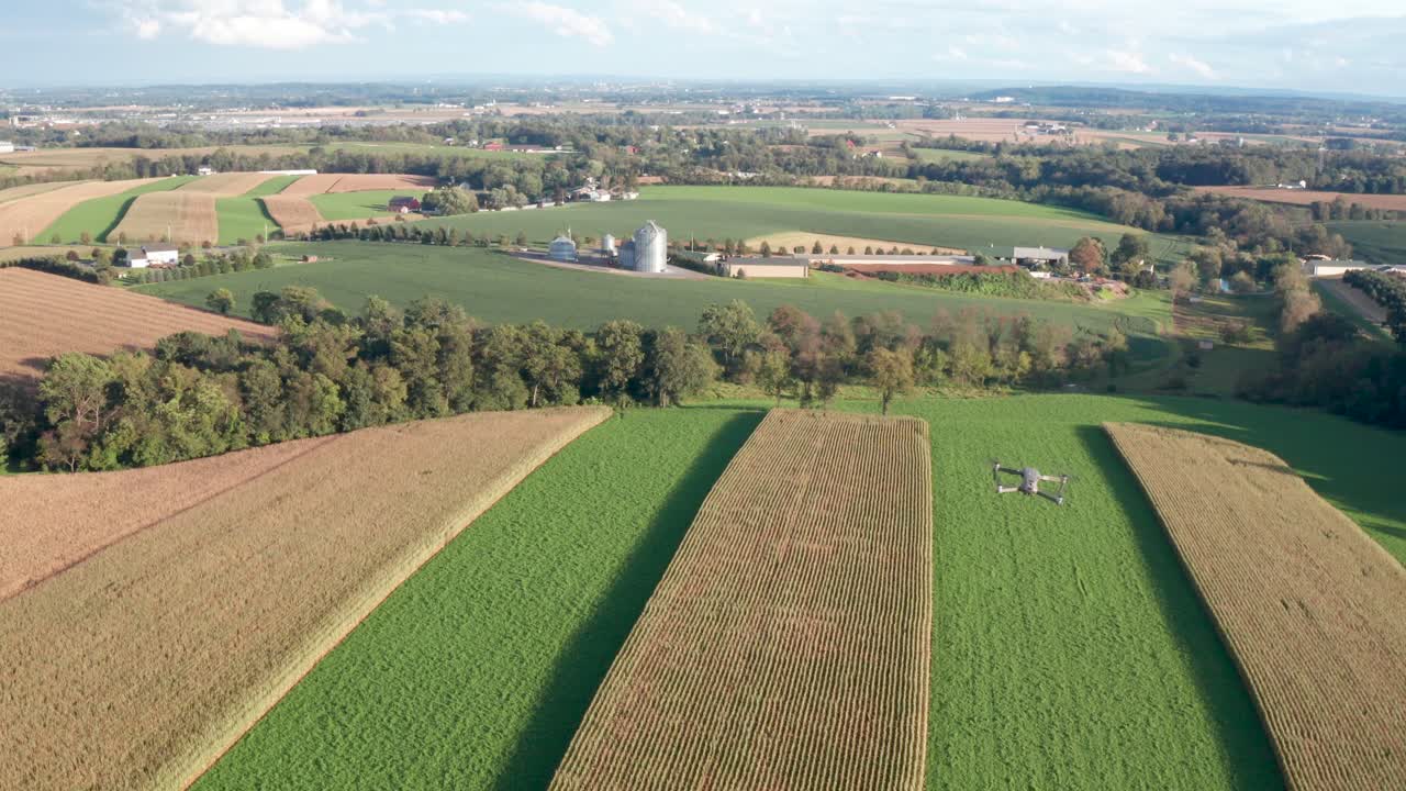 Aerial of drone flying in mid air above farm fields