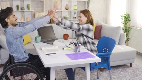 Disabled-male-student-in-wheelchair-rejoicing-with-his-girlfriend.