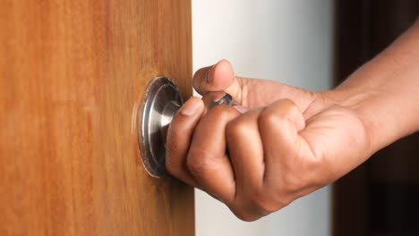 hand opening a door knob