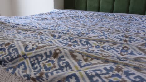 making a bed with patterned bedding