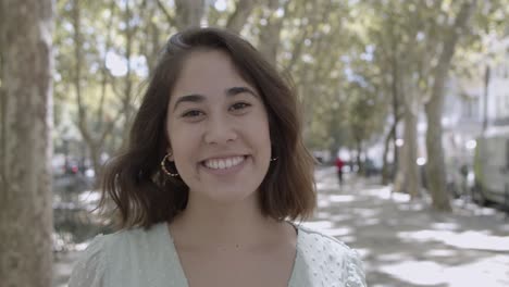 closeup portrait of young latin woman standing on street