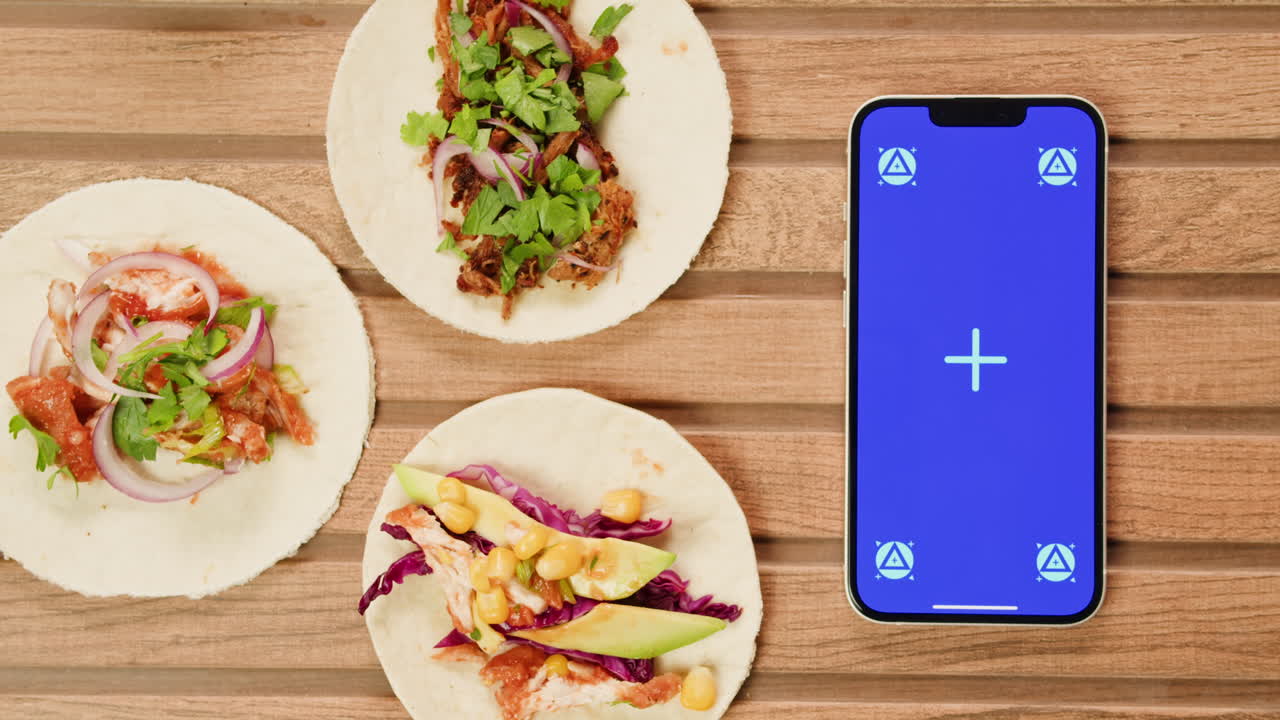 Tacos and a phone mockup on a wooden table