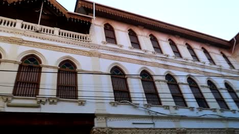 panning shot of an exuberant indian building in a residential area in stone town, zanzibar