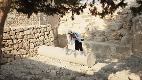 woman exploring ancient ruins