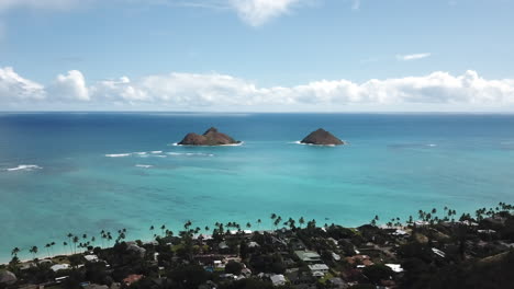 Aerial-of-seaside-neighborhood,-distant-islands-and-open-ocean,-Hawaii