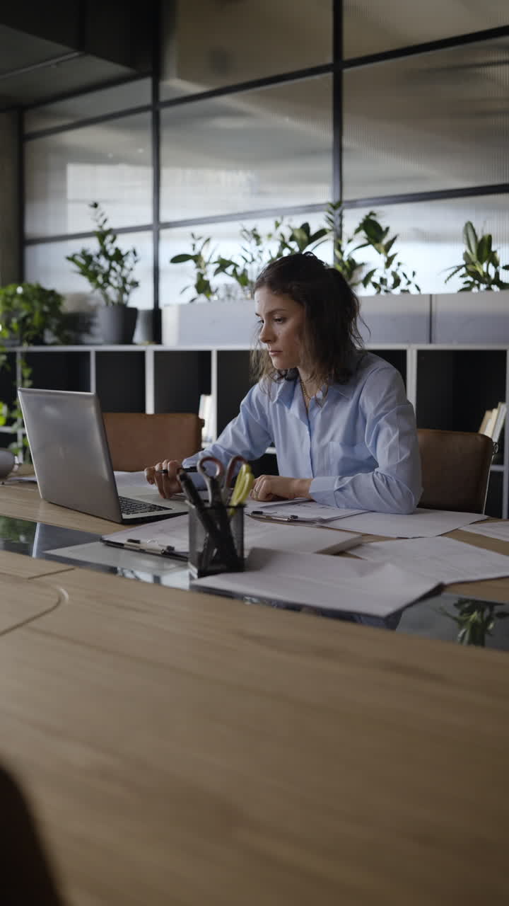 Woman working on documents in a modern office