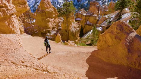 girl woman hiking with red rocks formation and snow near bryce canyon in southern utah-6