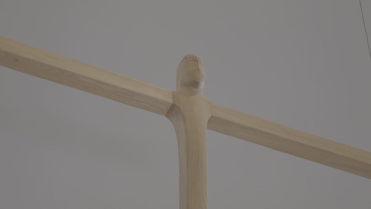 Close-up of an abstract wooden cross hanging in the sanctuary of a church