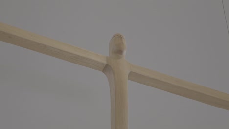close-up of an abstract wooden cross hanging in the sanctuary of a church