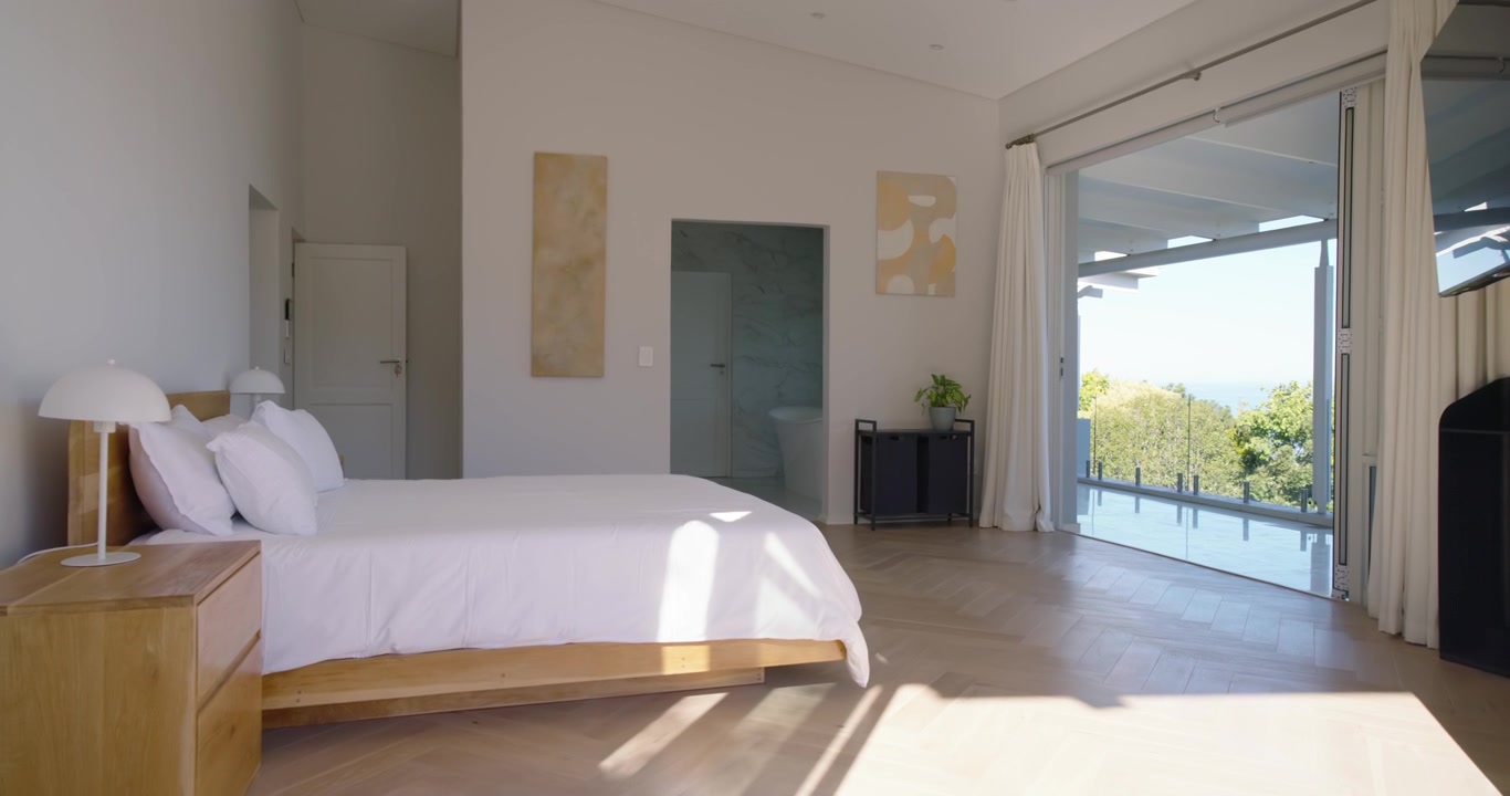 Operator is initiating pan and camera is panning right, revealing wooden bed, balcony view