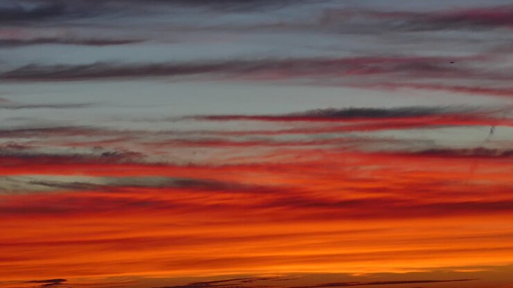 Dramatic Clouds Moving In The Sky During A Beautiful Orange Sunset