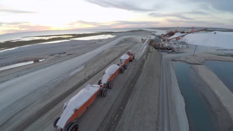 Aerial-drone-shot-of-a-large-truck-before-unloading-the-salt-salt-in-the-salt-flats-by-solar-evaporation-in-Guerrero-Negro,-Ojo-de-Liebre-lagoon,-Biosphere-Reserve-of-El-Vizcaino,-Baja-California-Sur