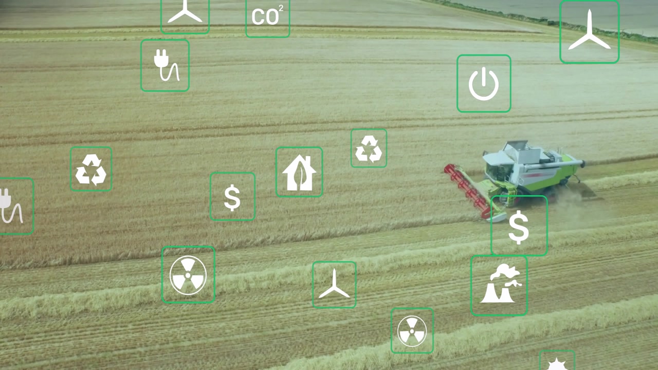 harvester starting, combine advancing left slicing wheat, icons drifting showing environmental data