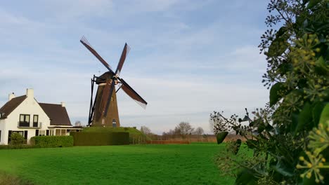 molino de viento tradicional holandés moviendo sus alas en el campo en los países bajos
