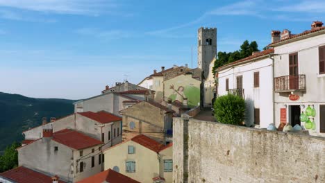 flyover shot of the old walled town of motovun, croatia on a bright afternoon