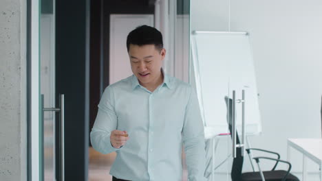 Businessman Holding Coin in Modern Office