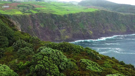 green cliffs of miradouro da ponta do queimado in terceira island, azores - aerial shot